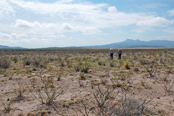 Two ranchers walk across the plains of drought-stricken West Texas in July 2011. (Photograph courtesy U.S. Department of Agriculture.)