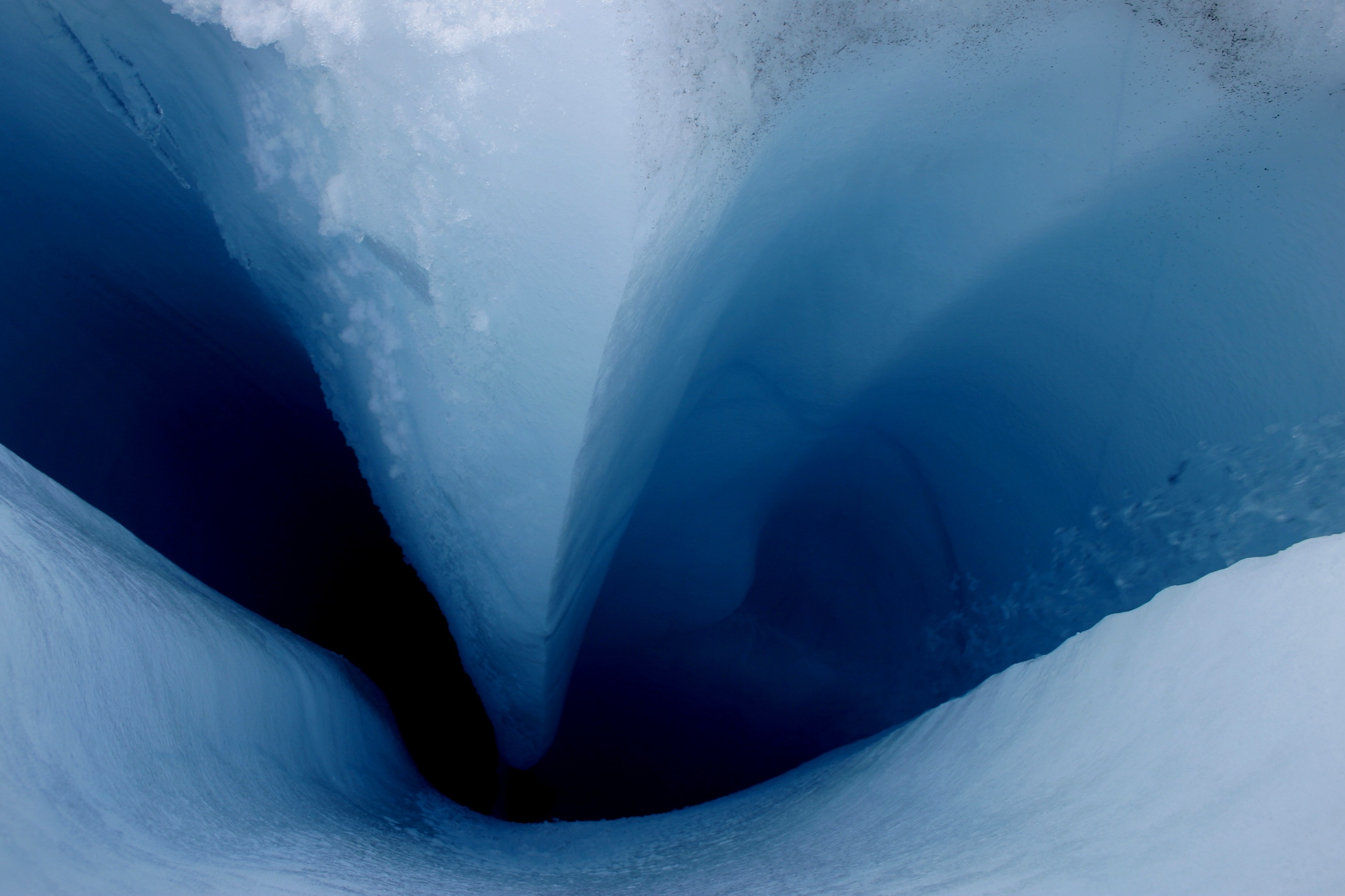 Meltwater from the surface of the Sermeq Avannarleq Glacier drains down toward interior ice (see falling droplets at right). This photograph depicts a region about 16 kilometers (10 miles) from the ice sheet margin in Southwest Greenland. CREDIT: William Colgan/CIRES